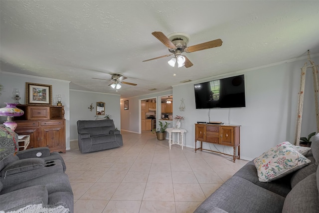 living room featuring ornamental molding, baseboards, a textured ceiling, a ceiling fan, and light tile patterned floors