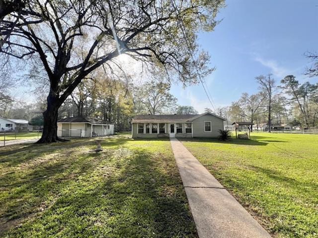 bungalow-style home featuring a front lawn