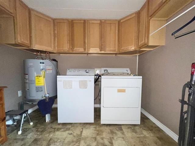 clothes washing area with water heater, baseboards, cabinet space, and independent washer and dryer