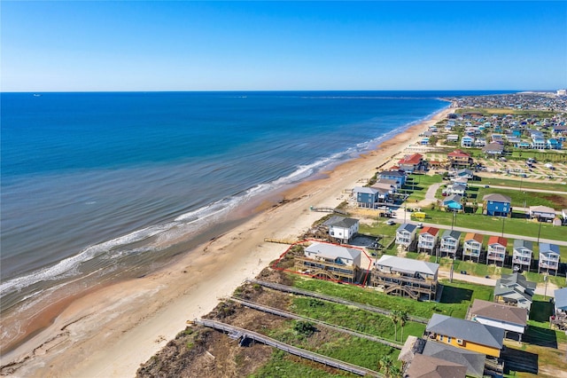 drone / aerial view with a water view and a beach view