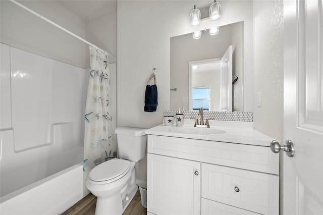 full bathroom featuring toilet, shower / bath combination with curtain, wood finished floors, and vanity