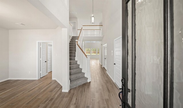 2617 Bisbee Rd, League City, TX 77573 - entrance foyer with stairs, baseboards, wood finished floors, and a high ceiling