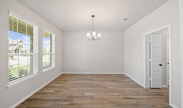 2617 Bisbee Rd, League City, TX 77573 - unfurnished room with a chandelier, wood finished floors, and baseboards