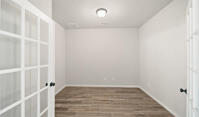 2617 Bisbee Rd, League City, TX 77573 - spare room with french doors, wood finished floors, and baseboards