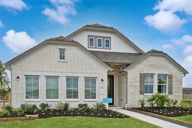 2617 Bisbee Rd, League City, TX 77573 - view of front of house with a shingled roof, board and batten siding, and stone siding
