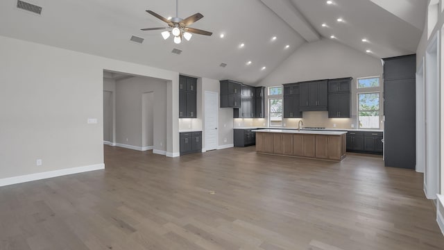 12944 Whitewater Way, Conroe, TX 77302 - kitchen featuring high vaulted ceiling, a ceiling fan, open floor plan, a kitchen island with sink, and recessed lighting