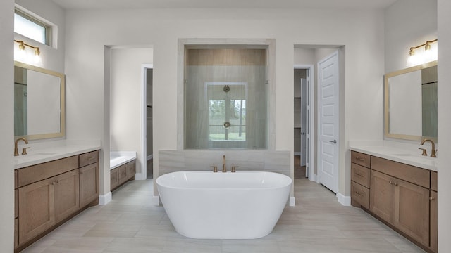 12944 Whitewater Way, Conroe, TX 77302 - full bathroom featuring a soaking tub, two vanities, and tile patterned floors