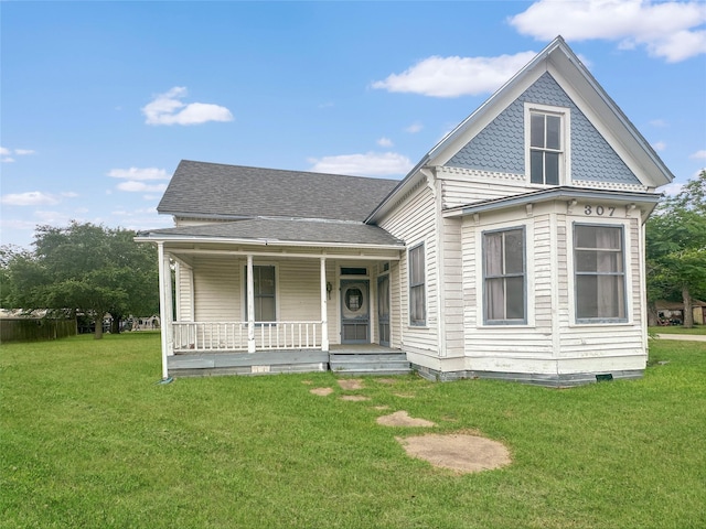 victorian home with a porch and a front yard
