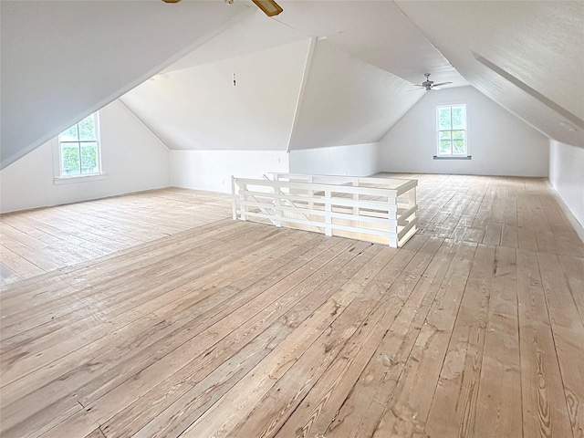additional living space featuring a ceiling fan, vaulted ceiling, and hardwood / wood-style flooring