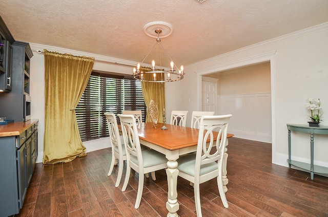 dining room featuring crown molding, a textured ceiling, a chandelier, baseboards, and dark wood-type flooring