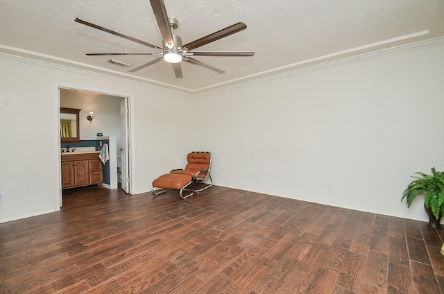 unfurnished room featuring crown molding, ceiling fan, a textured ceiling, dark wood-type flooring, and visible vents