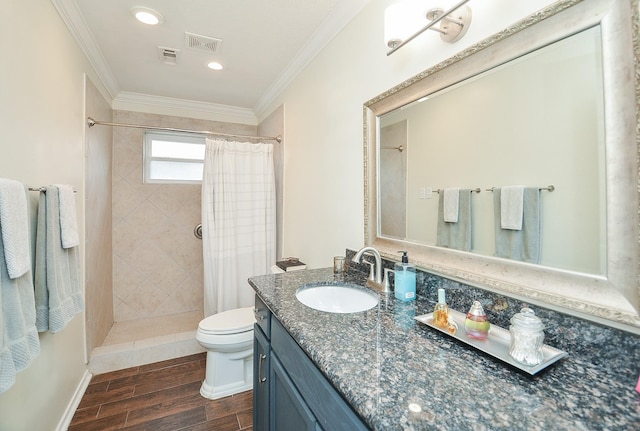 full bathroom featuring crown molding, vanity, wood finished floors, toilet, and tiled shower