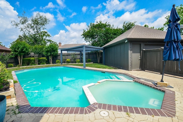 view of swimming pool with a fenced backyard, a patio area, and a pool with connected hot tub