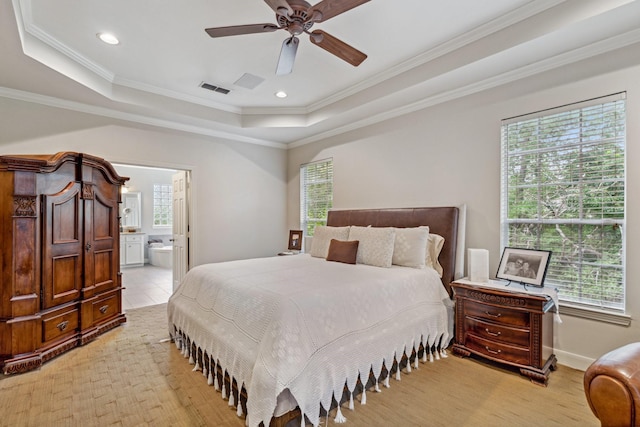 bedroom with a raised ceiling, recessed lighting, ensuite bathroom, visible vents, and ornamental molding