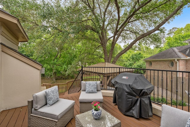 deck featuring a gazebo, outdoor lounge area, and a grill