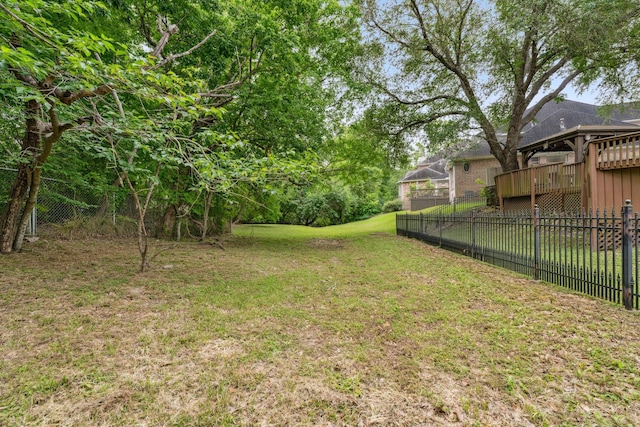 view of yard featuring fence and a deck