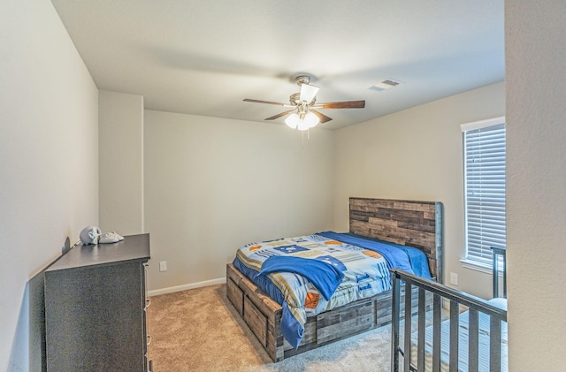 bedroom featuring ceiling fan, visible vents, light carpet, and multiple windows
