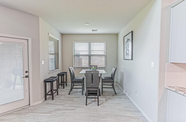 dining room featuring baseboards and visible vents