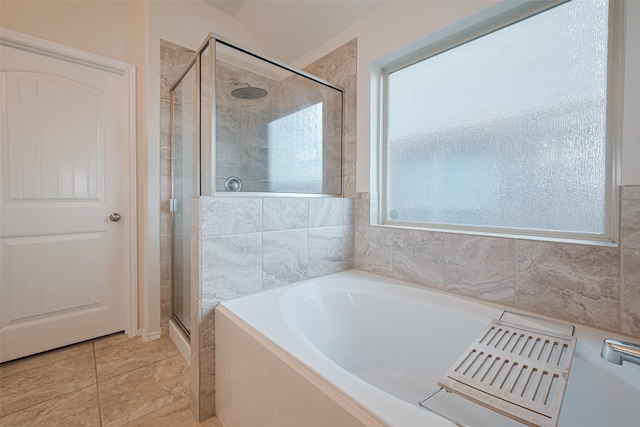full bath featuring a bath and a stall shower
