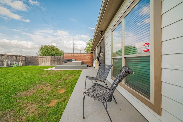 view of yard featuring a hot tub, a fenced backyard, and a patio area
