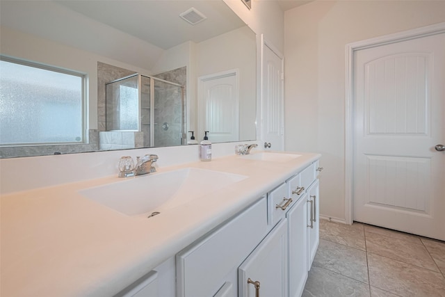 full bath featuring double vanity, visible vents, a sink, and a stall shower