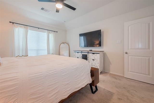 carpeted bedroom featuring baseboards, a ceiling fan, vaulted ceiling, and visible vents