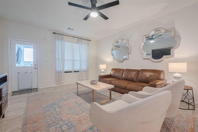 living area featuring ceiling fan and visible vents