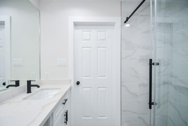 bathroom with vanity and a shower stall