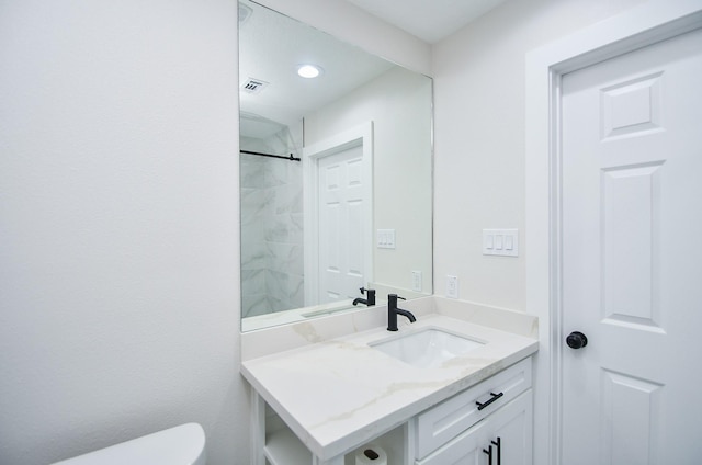 bathroom featuring walk in shower, toilet, recessed lighting, and vanity