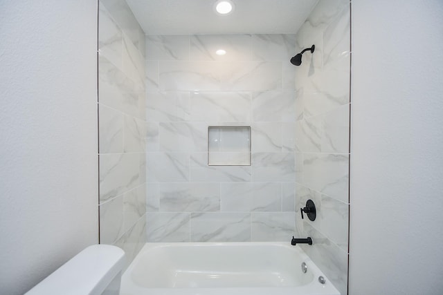 bathroom with toilet and bathing tub / shower combination
