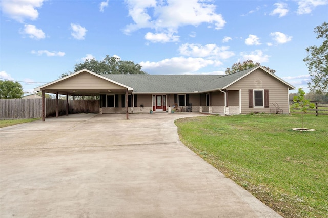 ranch-style house with covered porch, a front yard, a carport, fence, and concrete driveway