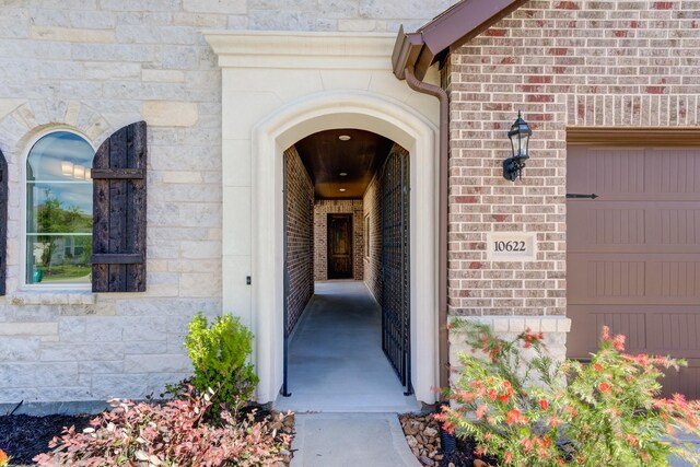 doorway to property with brick siding and stone siding