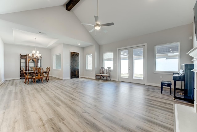 living room with visible vents, light wood-style floors, beam ceiling, and a fireplace
