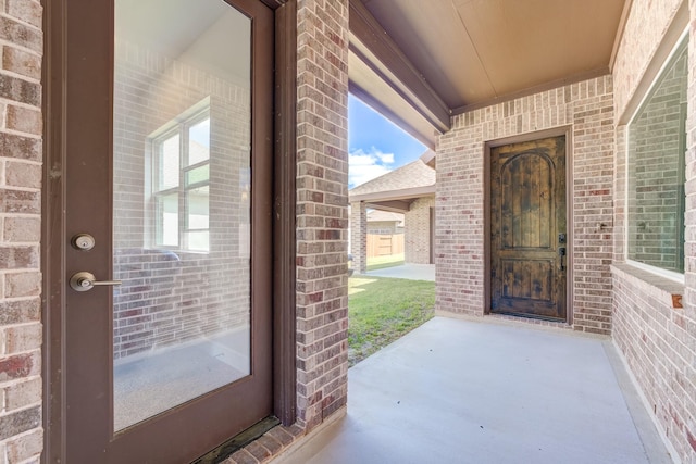 property entrance featuring brick siding