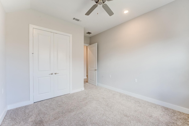 unfurnished bedroom featuring carpet flooring, ceiling fan, baseboards, visible vents, and a closet