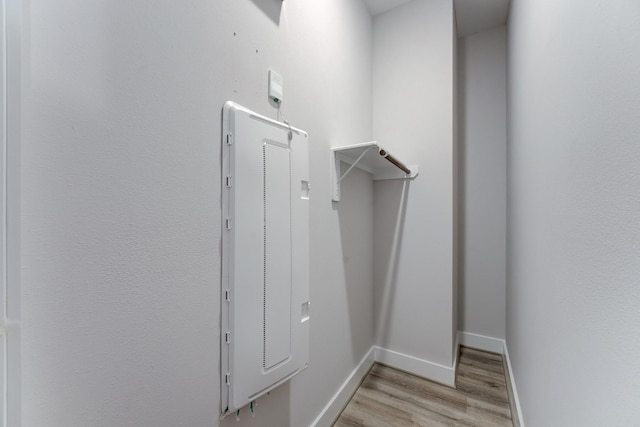 washroom featuring baseboards and light wood-style flooring