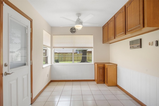 711 Rosewood Dr, Shenandoah, TX 77381 - unfurnished dining area featuring ceiling fan, baseboards, and wainscoting