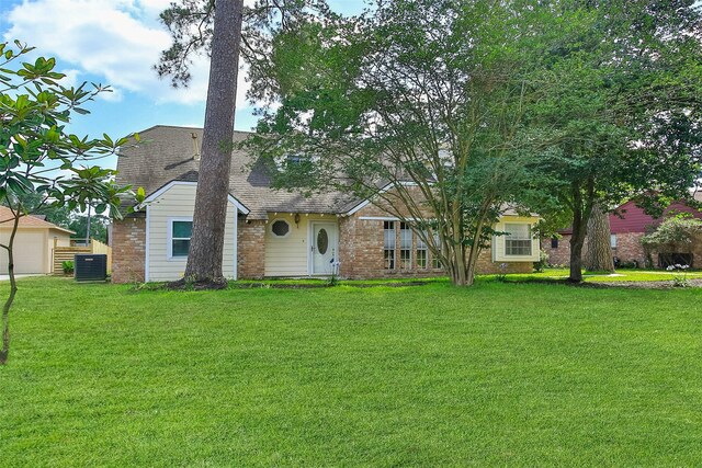 711 Rosewood Dr, Shenandoah, TX 77381 - view of front of home featuring brick siding, a front yard, central AC, and roof with shingles