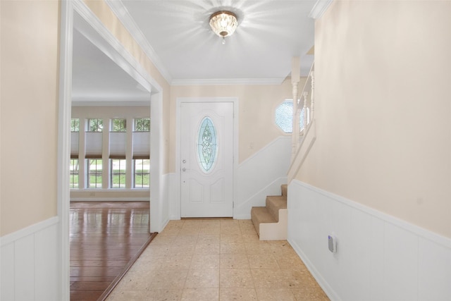 711 Rosewood Dr, Shenandoah, TX 77381 - entryway featuring wainscoting, healthy amount of natural light, a decorative wall, ornamental molding, and stairway