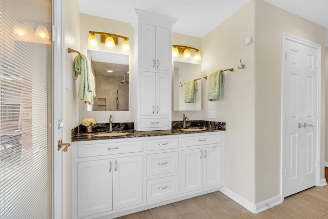 711 Rosewood Dr, Shenandoah, TX 77381 - bathroom with tile patterned floors, double vanity, and baseboards