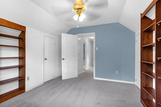 711 Rosewood Dr, Shenandoah, TX 77381 - unfurnished bedroom with lofted ceiling, carpet floors, and baseboards