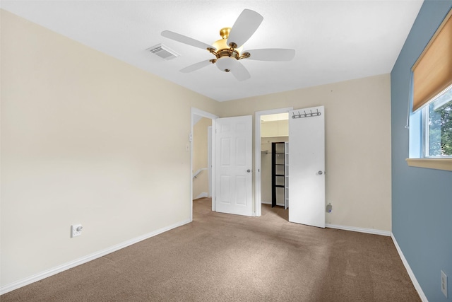 711 Rosewood Dr, Shenandoah, TX 77381 - unfurnished bedroom with carpet, a walk in closet, baseboards, ceiling fan, and a closet