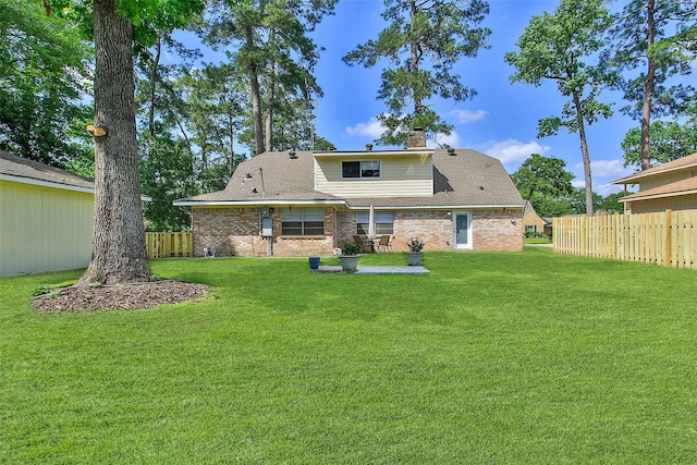 711 Rosewood Dr, Shenandoah, TX 77381 - back of house with a chimney, brick siding, a patio area, and roof with shingles