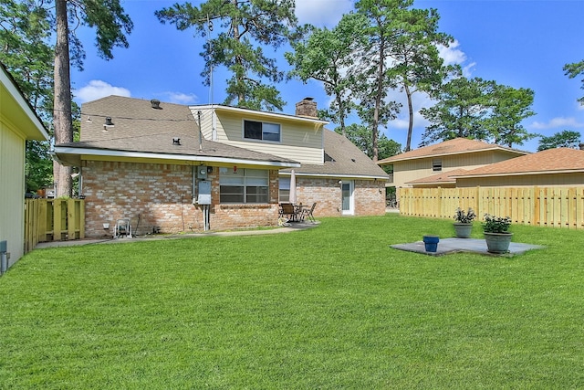 711 Rosewood Dr, Shenandoah, TX 77381 - back of house featuring a chimney, brick siding, a patio area, and a shingled roof