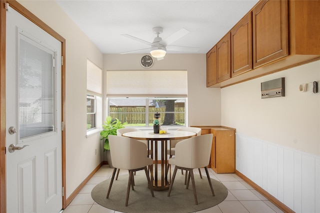 711 Rosewood Dr, Shenandoah, TX 77381 - dining room featuring ceiling fan, light tile patterned floors, and a wainscoted wall