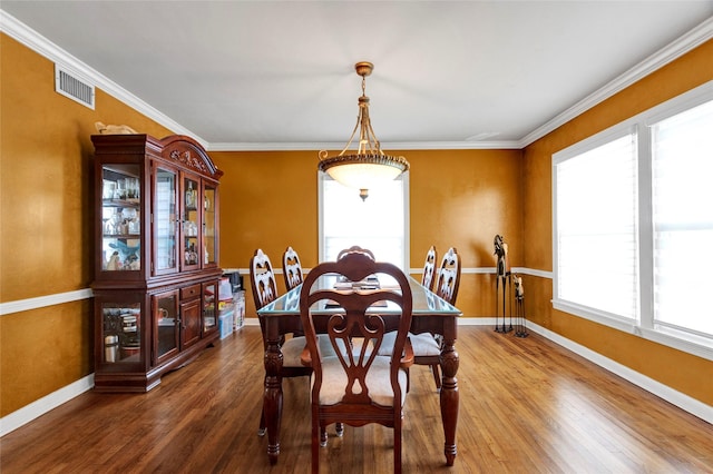 dining room with baseboards, wood finished floors, and a wealth of natural light