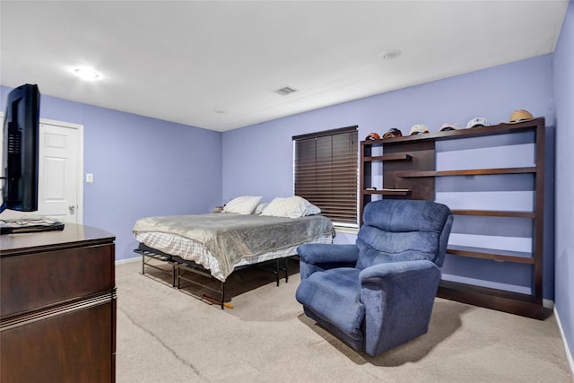 carpeted bedroom featuring baseboards and visible vents
