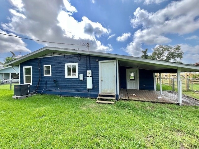 back of property featuring a lawn, central AC unit, fence, and entry steps