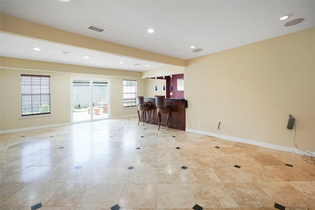 living room featuring visible vents, a dry bar, baseboards, and recessed lighting