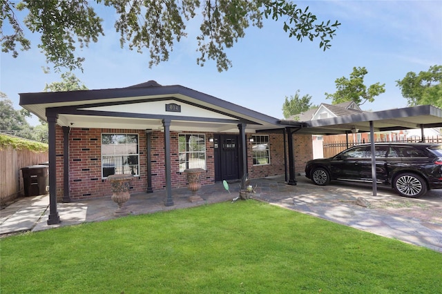 view of front of house with fence, brick siding, and a front yard